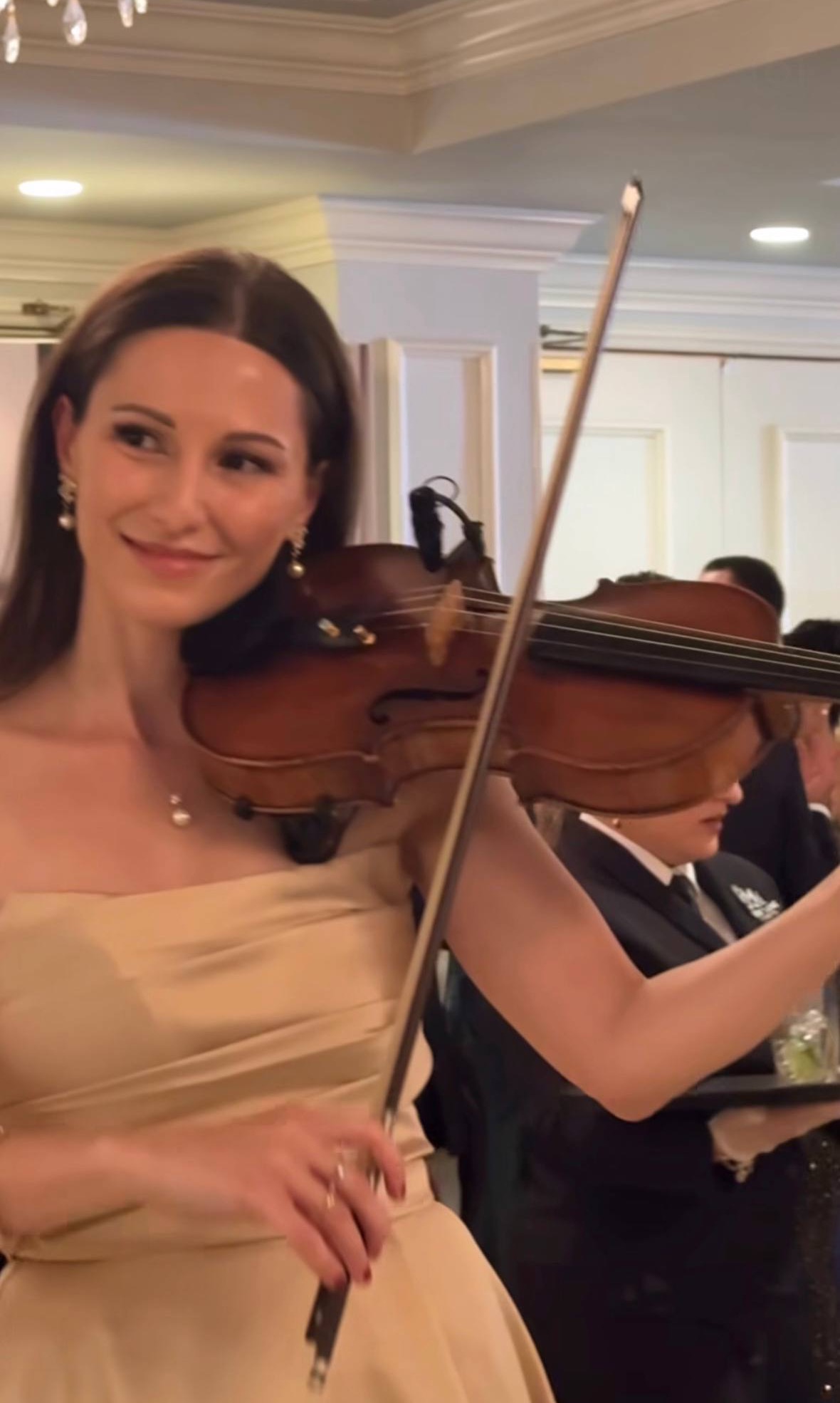 Tatev Muradyan playing violin at a ballroom reception