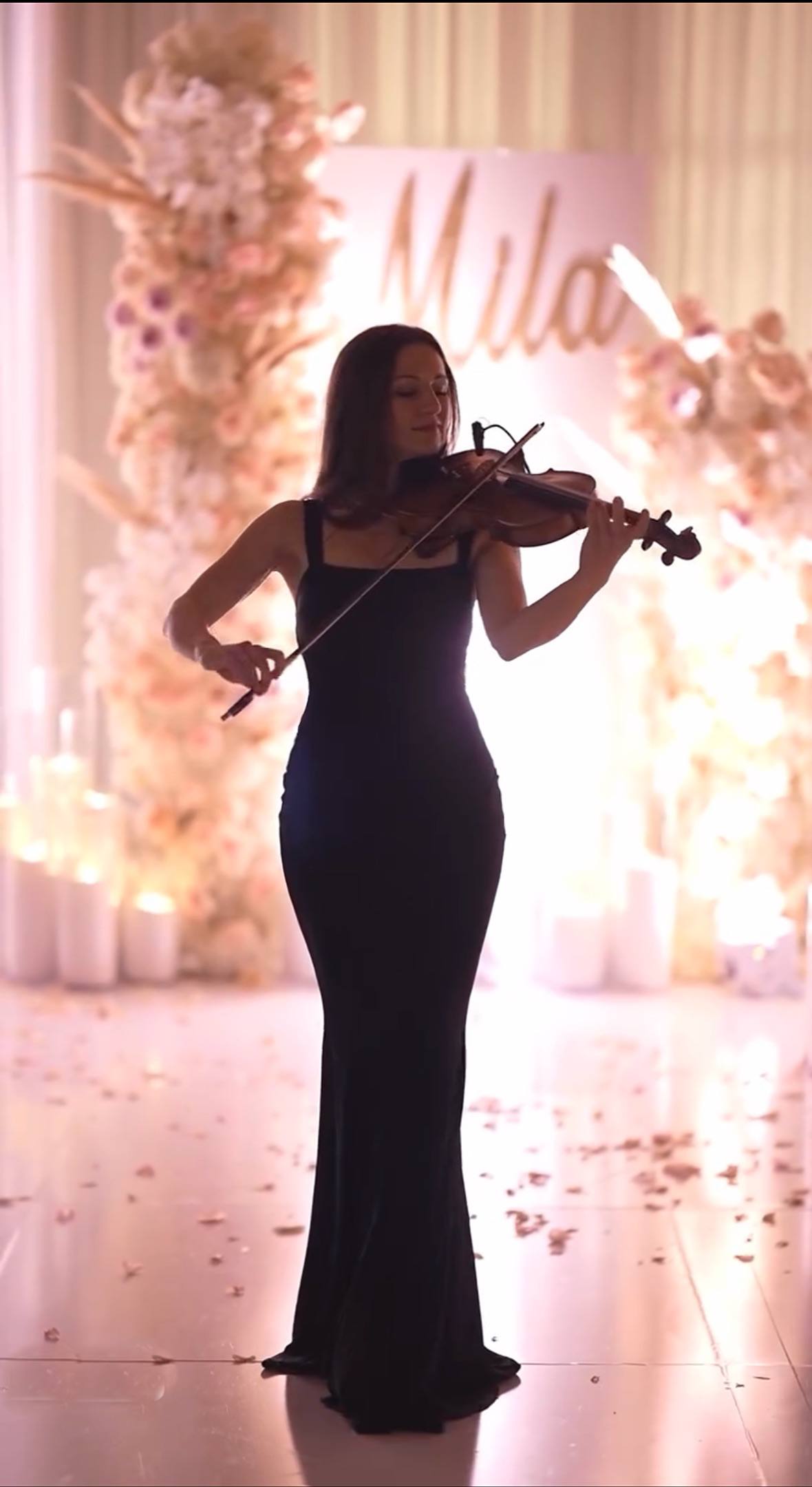 Tatev Muradyan performing in front of a floral backdrop