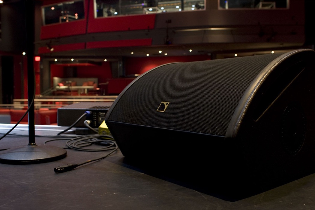 Professional stage monitor speaker set up in a concert hall